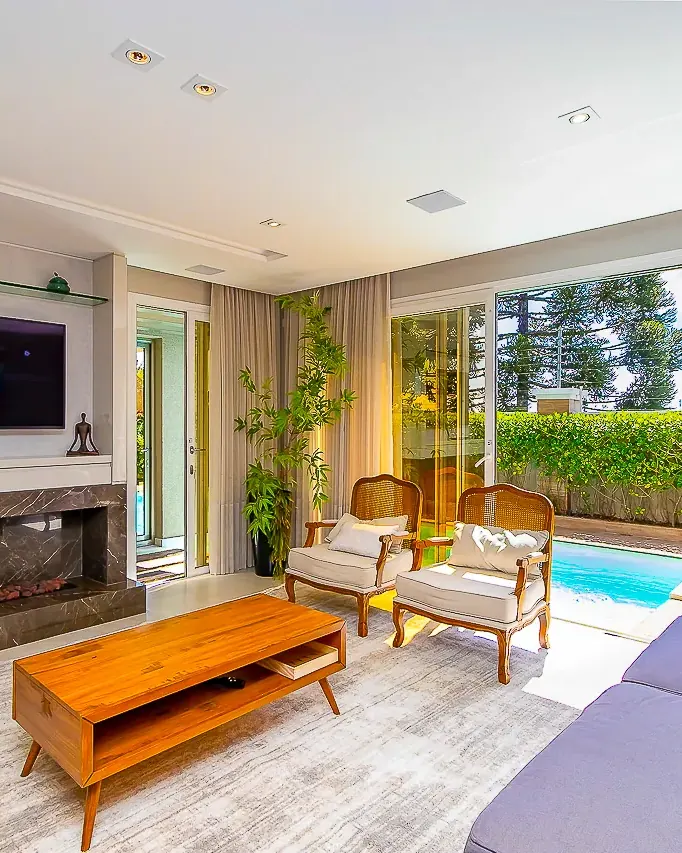 Sala com lareira e vista para a piscina — fotos para anúncio no Airbnb
